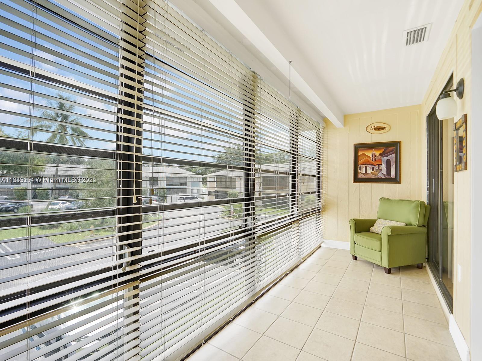 9727 Hammocks Boulevard, Unit 201D Miami, FL 33196 - Photo 13 of 25 a view of a balcony with couch