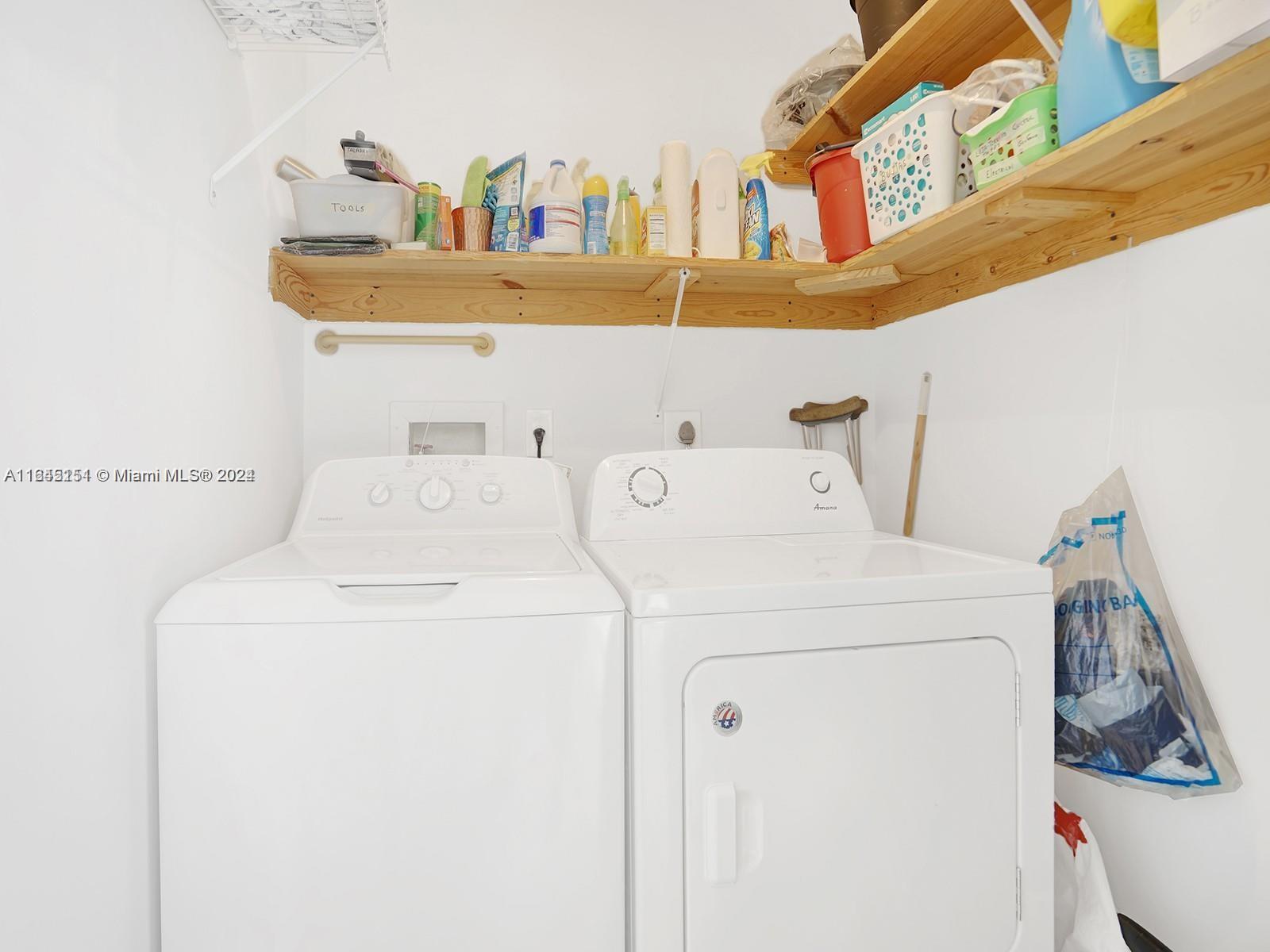 9727 Hammocks Boulevard, Unit 201D Miami, FL 33196 - Photo 14 of 25 a utility room with dryer and washer