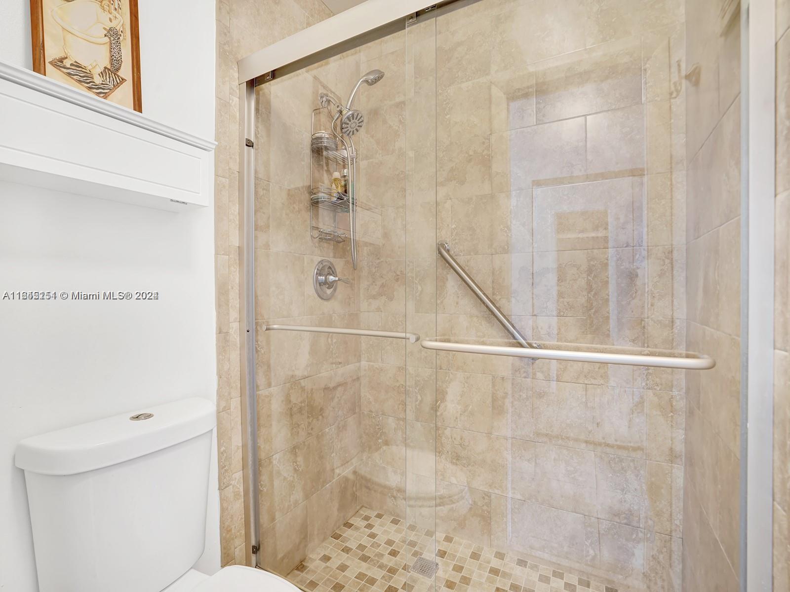 9727 Hammocks Boulevard, Unit 201D Miami, FL 33196 - Photo 16 of 25 a bathroom with a shower and a toilet