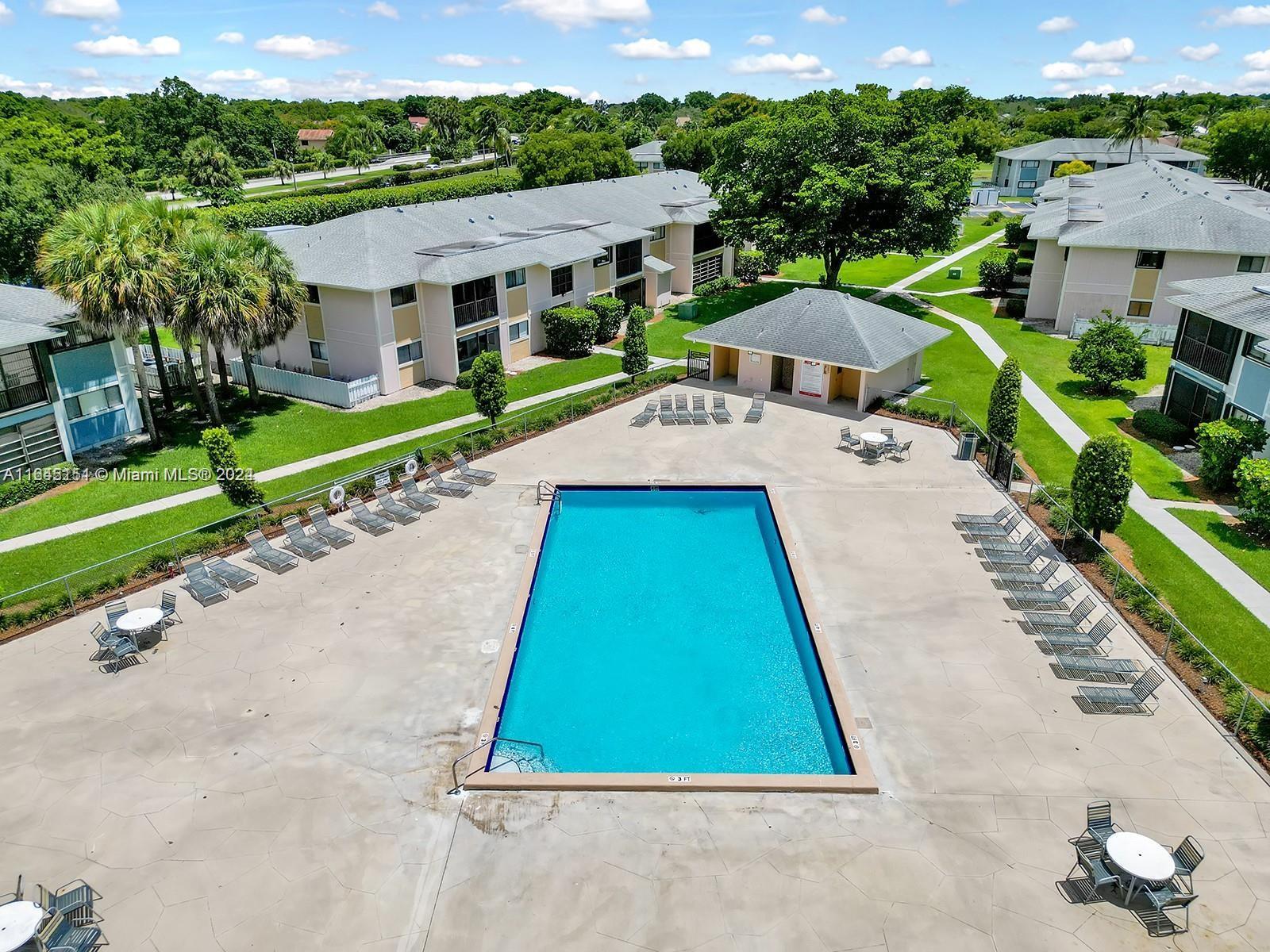 9727 Hammocks Boulevard, Unit 201D Miami, FL 33196 - Photo 18 of 25 a view of house with a yard and potted plants