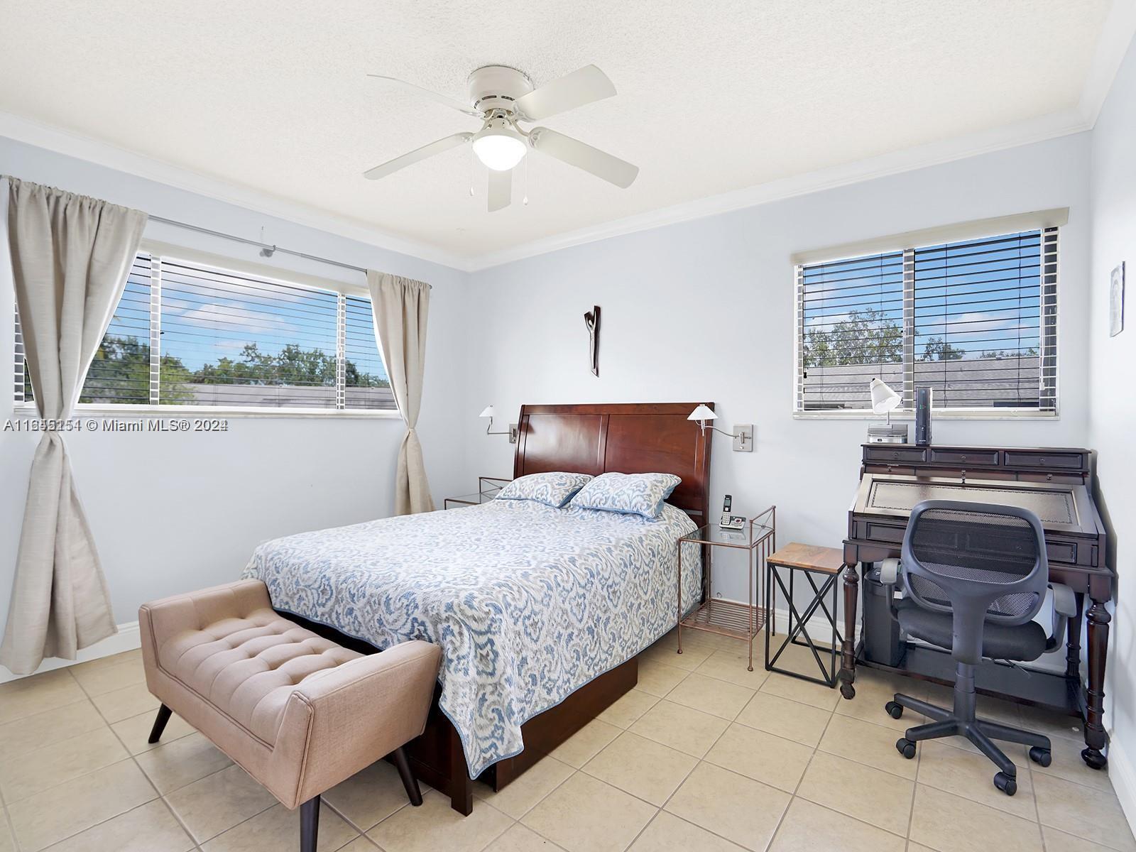 9727 Hammocks Boulevard, Unit 201D Miami, FL 33196 - Photo 2 of 25 a bedroom with furniture and a large window