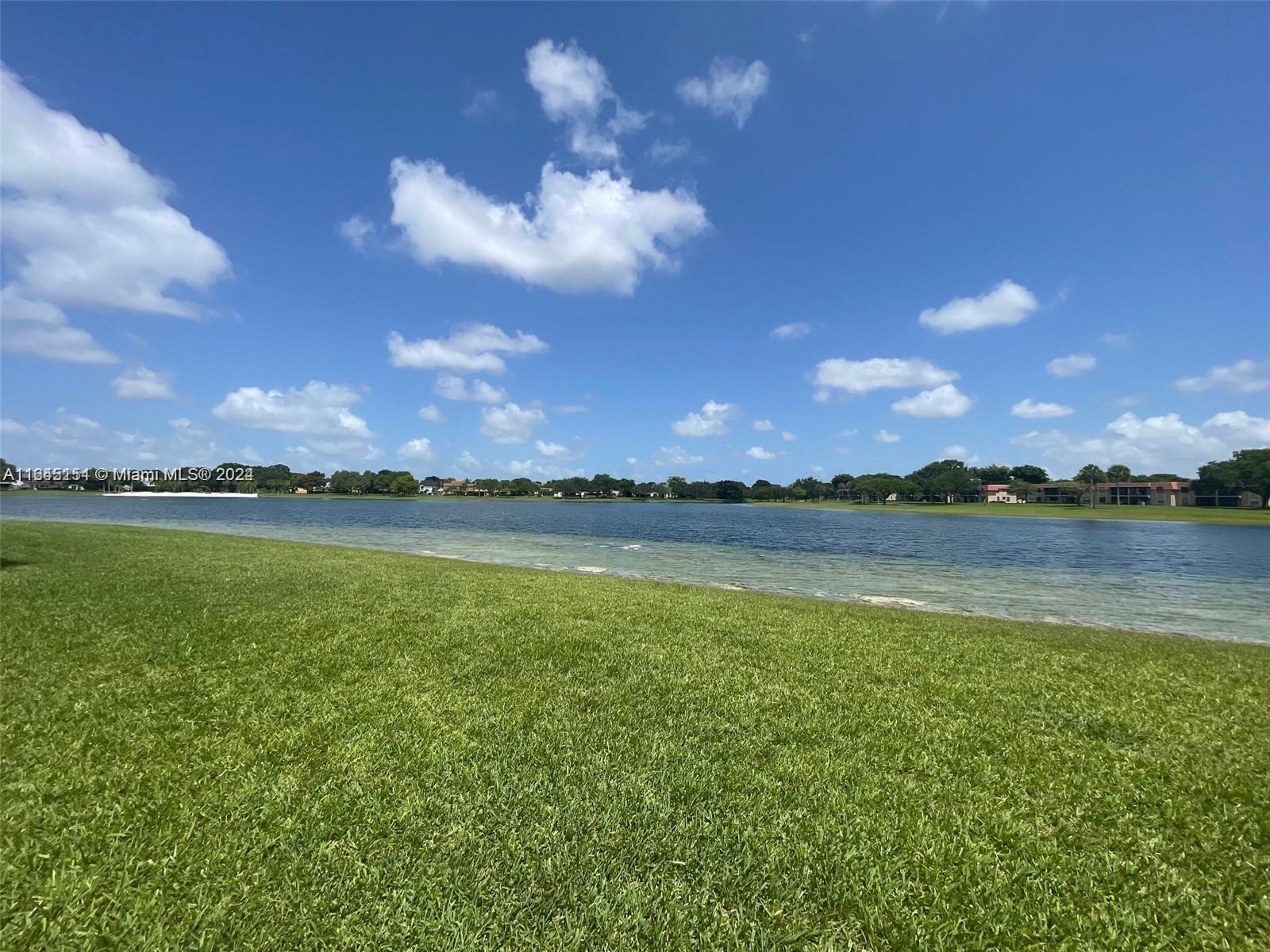 9727 Hammocks Boulevard, Unit 201D Miami, FL 33196 - Photo 24 of 25 a view of an lake and a yard
