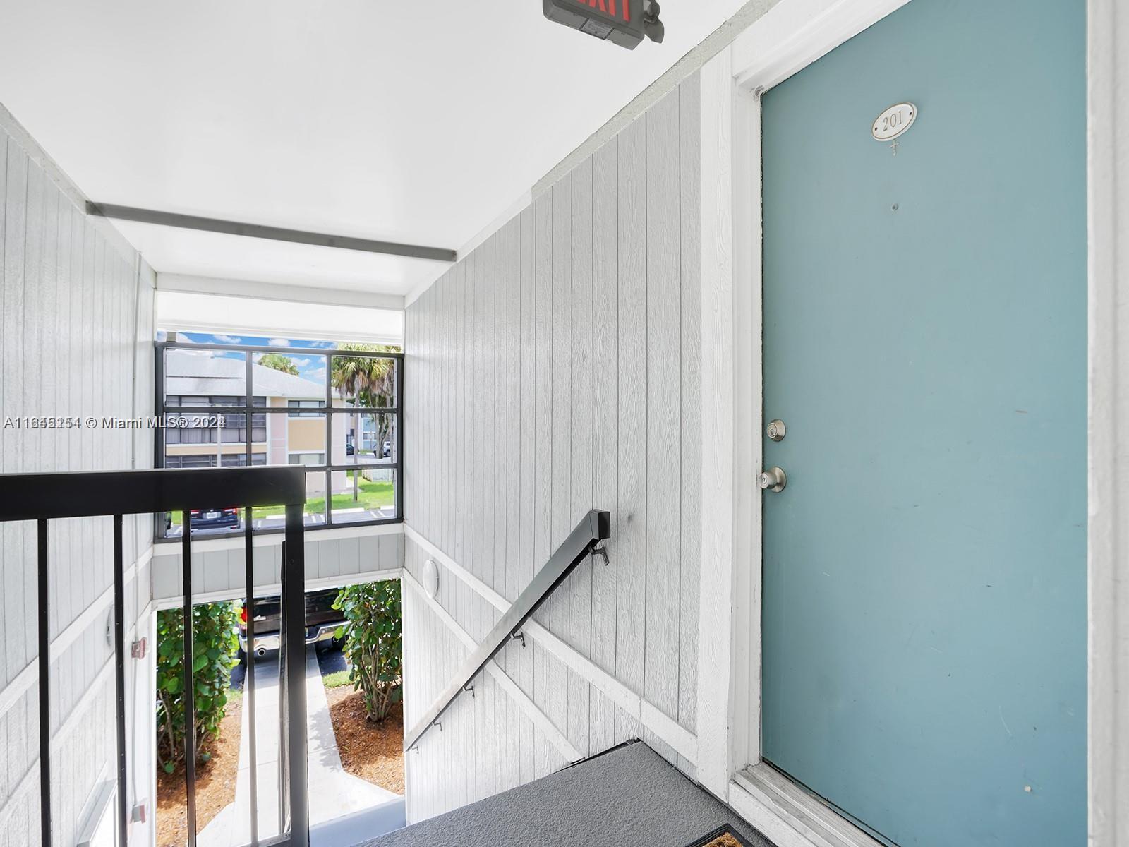 9727 Hammocks Boulevard, Unit 201D Miami, FL 33196 - Photo 6 of 25 a view of an entryway with wooden floor