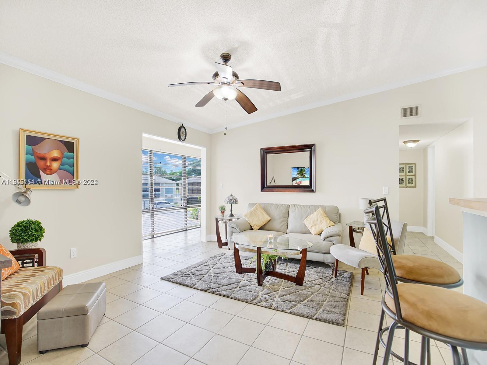 9727 Hammocks Boulevard, Unit 201D Miami, FL 33196 - Photo 7 of 25 a living room with furniture and wooden floor