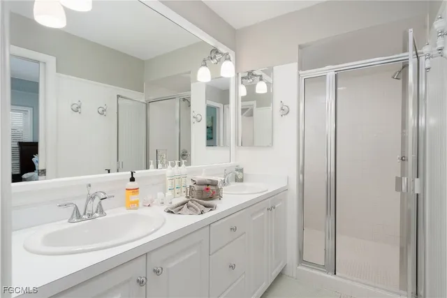 a bathroom with double vanity sinks and a mirror