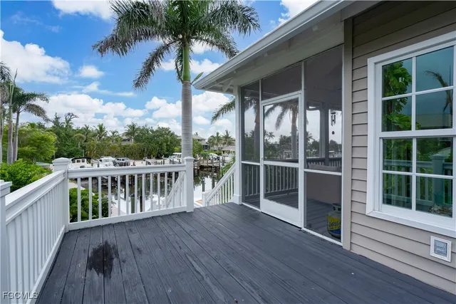 a balcony with wooden floor and fence