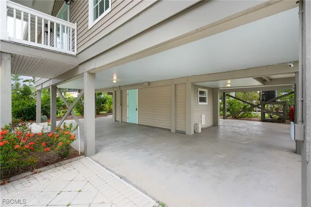 a view of a porch with furniture and a yard