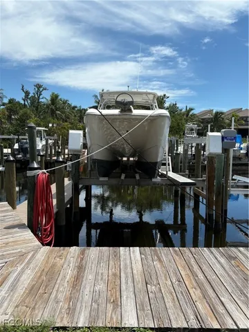a view of a roof deck with dining table and chairs