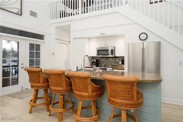 a dining room with furniture and wooden floor