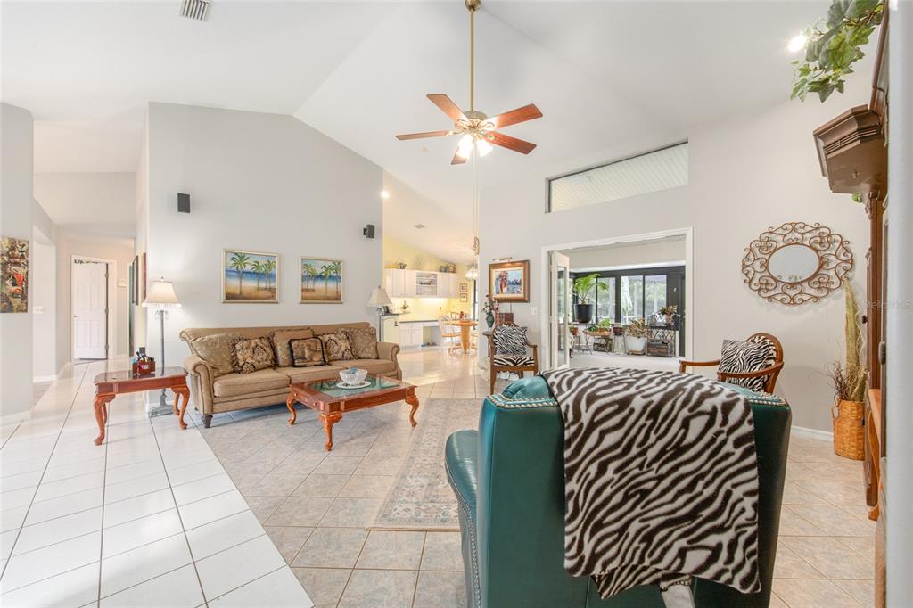 2305 Southeast 30th Street Ocala, FL 34471 - Photo 13 of 66 a living room with furniture a chandelier fan and a window