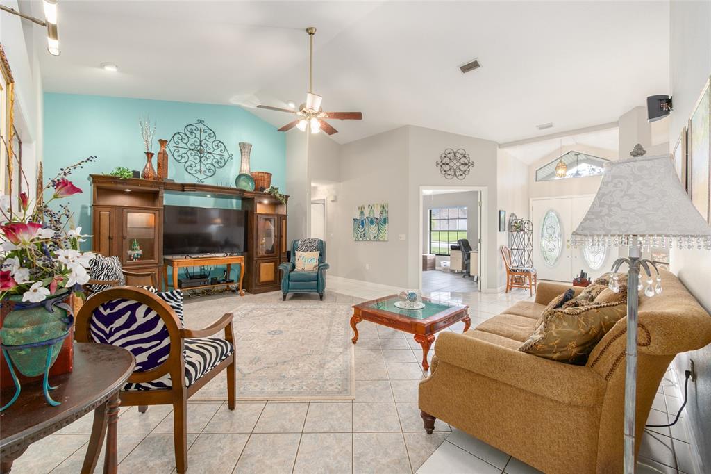 2305 Southeast 30th Street Ocala, FL 34471 - Photo 14 of 66 a living room with furniture a flat screen tv and a chandelier