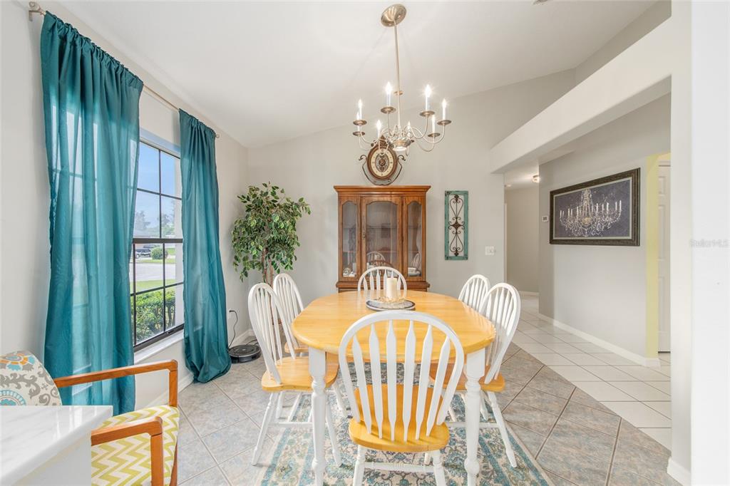 2305 Southeast 30th Street Ocala, FL 34471 - Photo 15 of 66 a dining room with furniture a livingroom and chandelier
