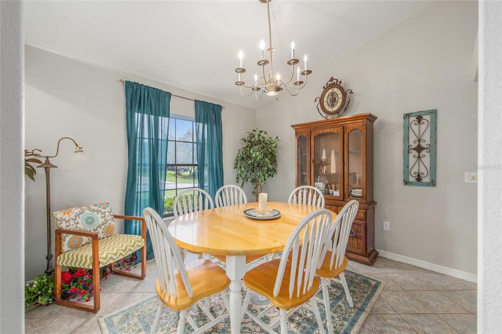 2305 Southeast 30th Street Ocala, FL 34471 - Photo 17 of 66 a view of a dining room with furniture and chandelier