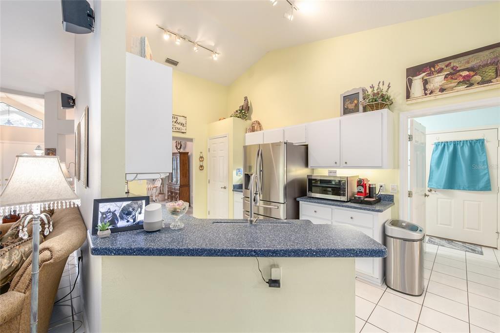 2305 Southeast 30th Street Ocala, FL 34471 - Photo 18 of 66 a kitchen with stainless steel appliances granite countertop a sink refrigerator and cabinets