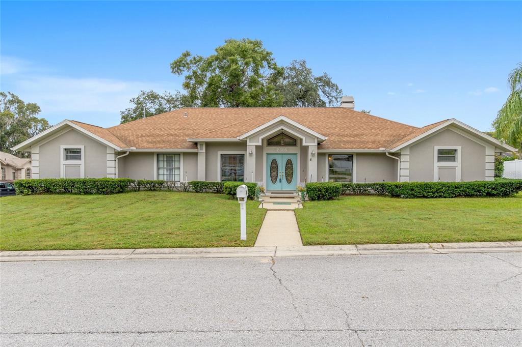 2305 Southeast 30th Street Ocala, FL 34471 - Photo 2 of 66 a front view of a house with a garden and trees