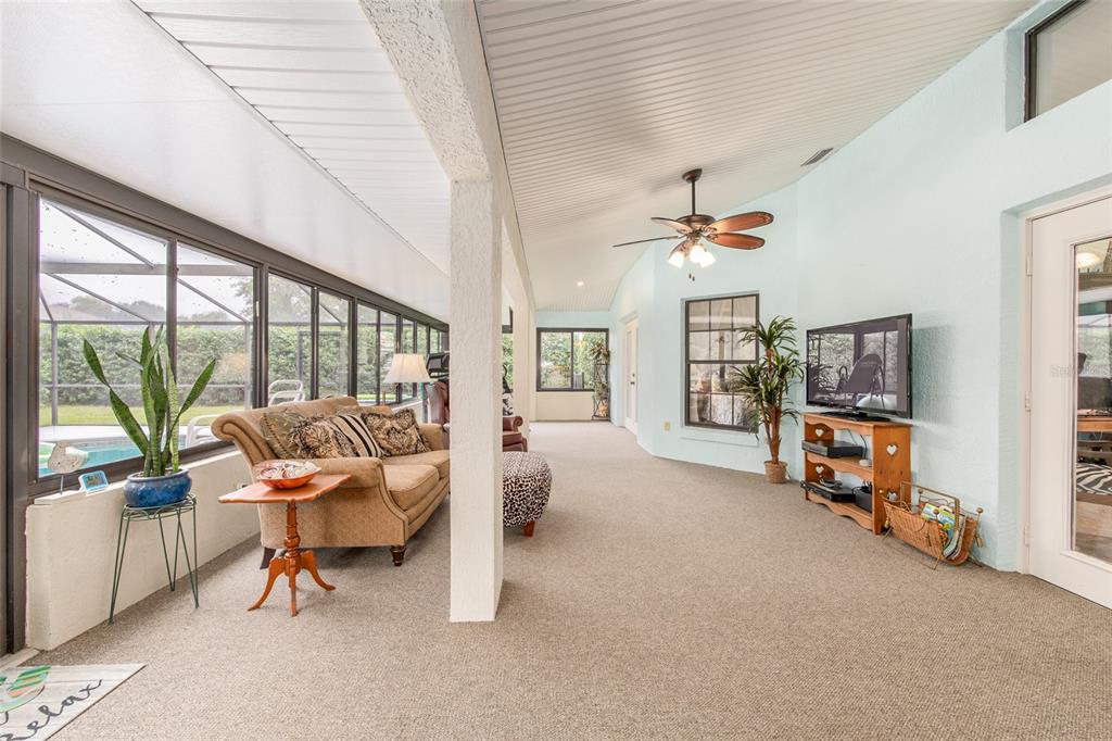 2305 Southeast 30th Street Ocala, FL 34471 - Photo 28 of 66 a living room with furniture and a chandelier