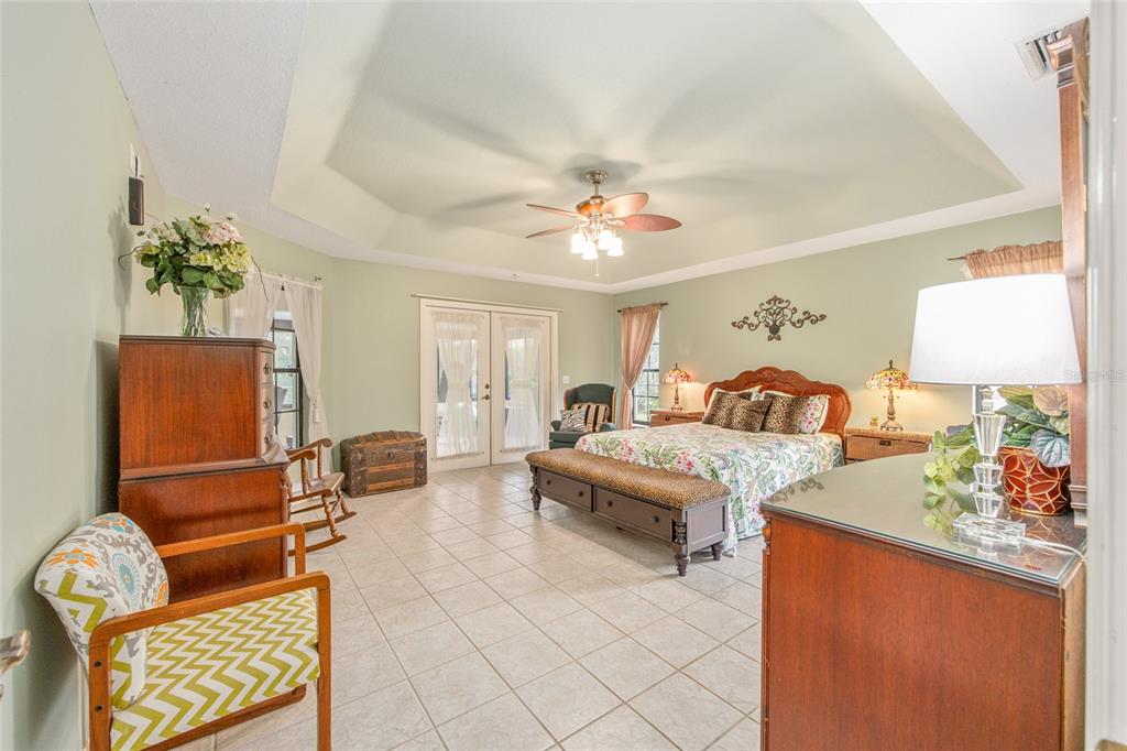 2305 Southeast 30th Street Ocala, FL 34471 - Photo 30 of 66 a bedroom with furniture and a chandelier