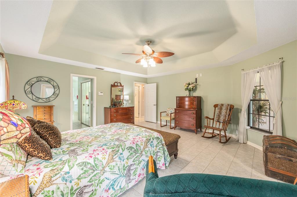 2305 Southeast 30th Street Ocala, FL 34471 - Photo 31 of 66 a bedroom with bed and a chandelier