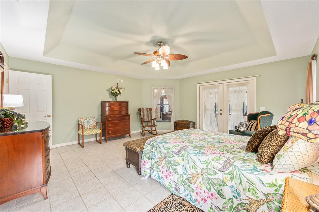 2305 Southeast 30th Street Ocala, FL 34471 - Photo 32 of 66 a bedroom with a bed and a chandelier