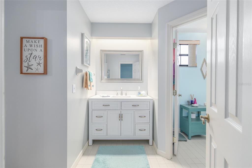 2305 Southeast 30th Street Ocala, FL 34471 - Photo 44 of 66 a spacious bathroom with a double vanity sink and a mirror