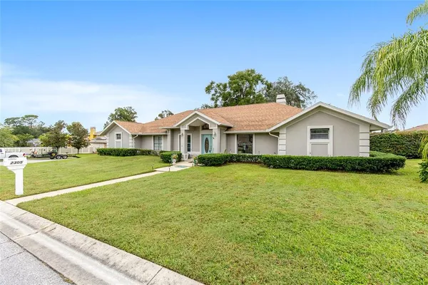 a front view of house with yard and swimming pool