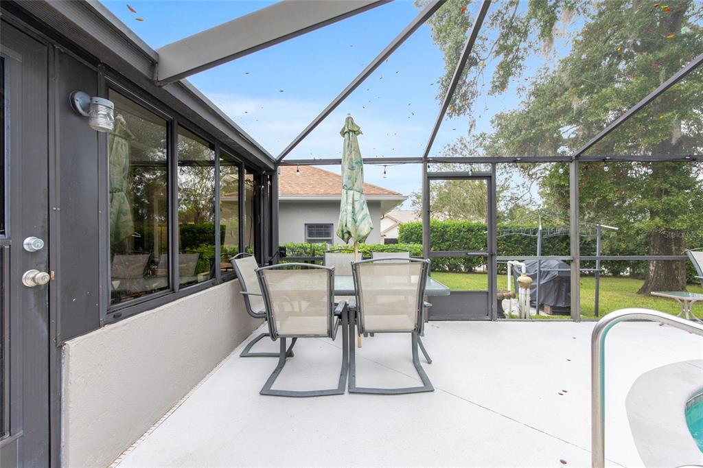 2305 Southeast 30th Street Ocala, FL 34471 - Photo 57 of 66 a view of a patio with a dining table and chairs
