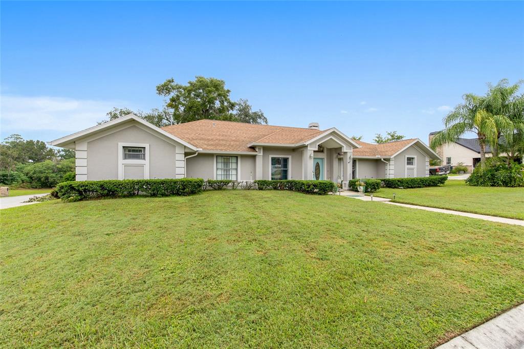 2305 Southeast 30th Street Ocala, FL 34471 - Photo 6 of 66 a front view of a house with a garden