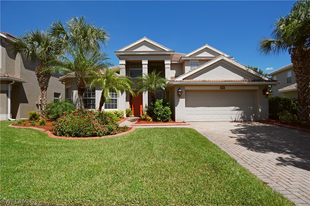 12439 Rock Ridge Lane Fort Myers, FL 33913 - Photo 1 of 35 a front view of a house with a yard
