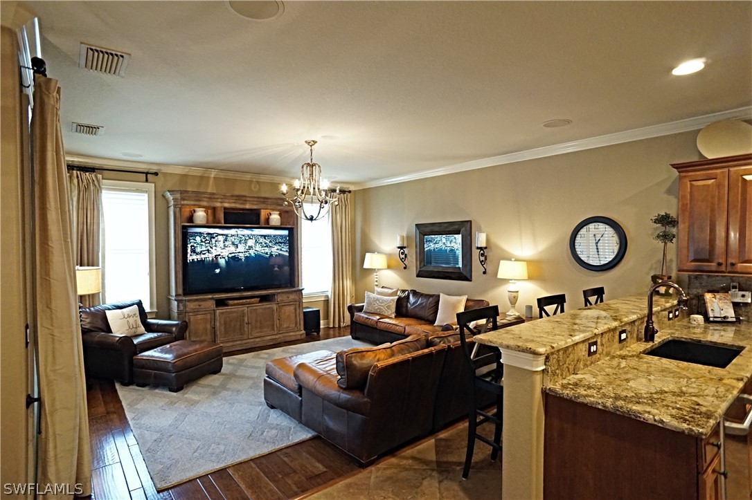 12439 Rock Ridge Lane Fort Myers, FL 33913 - Photo 12 of 35 a living room with furniture and a flat screen tv