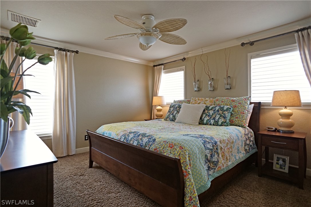 12439 Rock Ridge Lane Fort Myers, FL 33913 - Photo 29 of 35 a large bed sitting in a bedroom next to a window