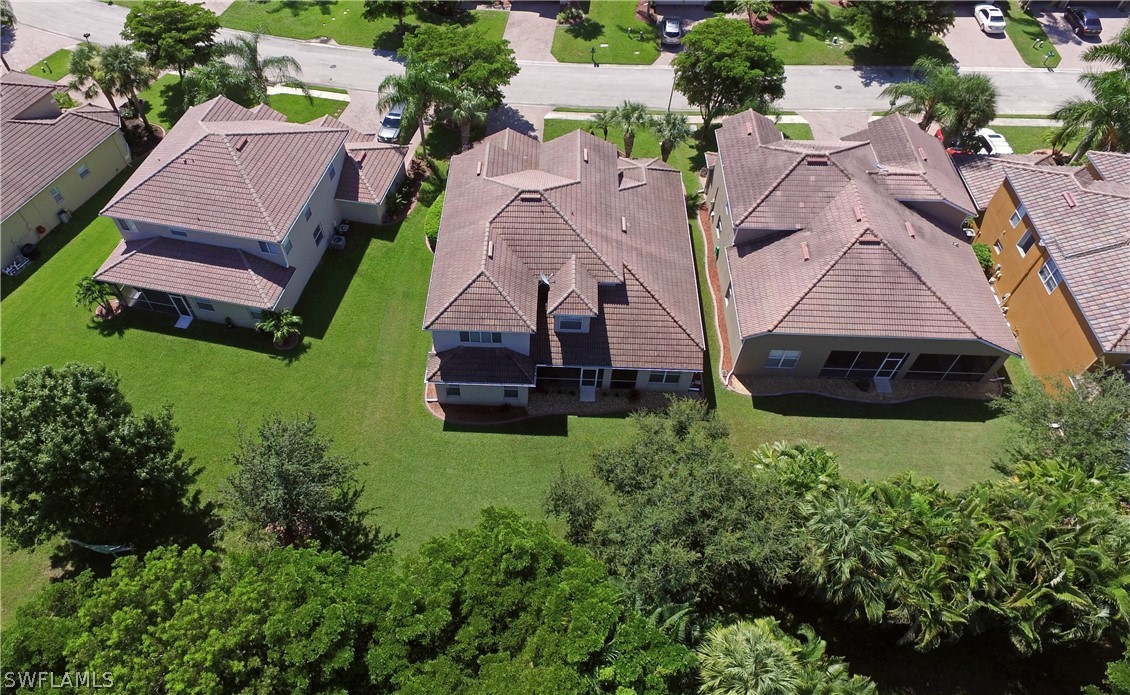 12439 Rock Ridge Lane Fort Myers, FL 33913 - Photo 34 of 35 an aerial view of multiple houses with yard