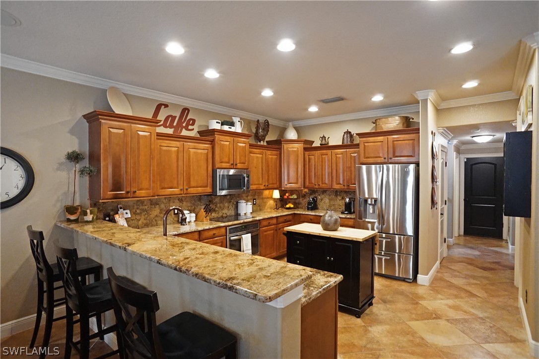12439 Rock Ridge Lane Fort Myers, FL 33913 - Photo 8 of 35 a kitchen with granite countertop a sink a counter top space appliances and cabinets