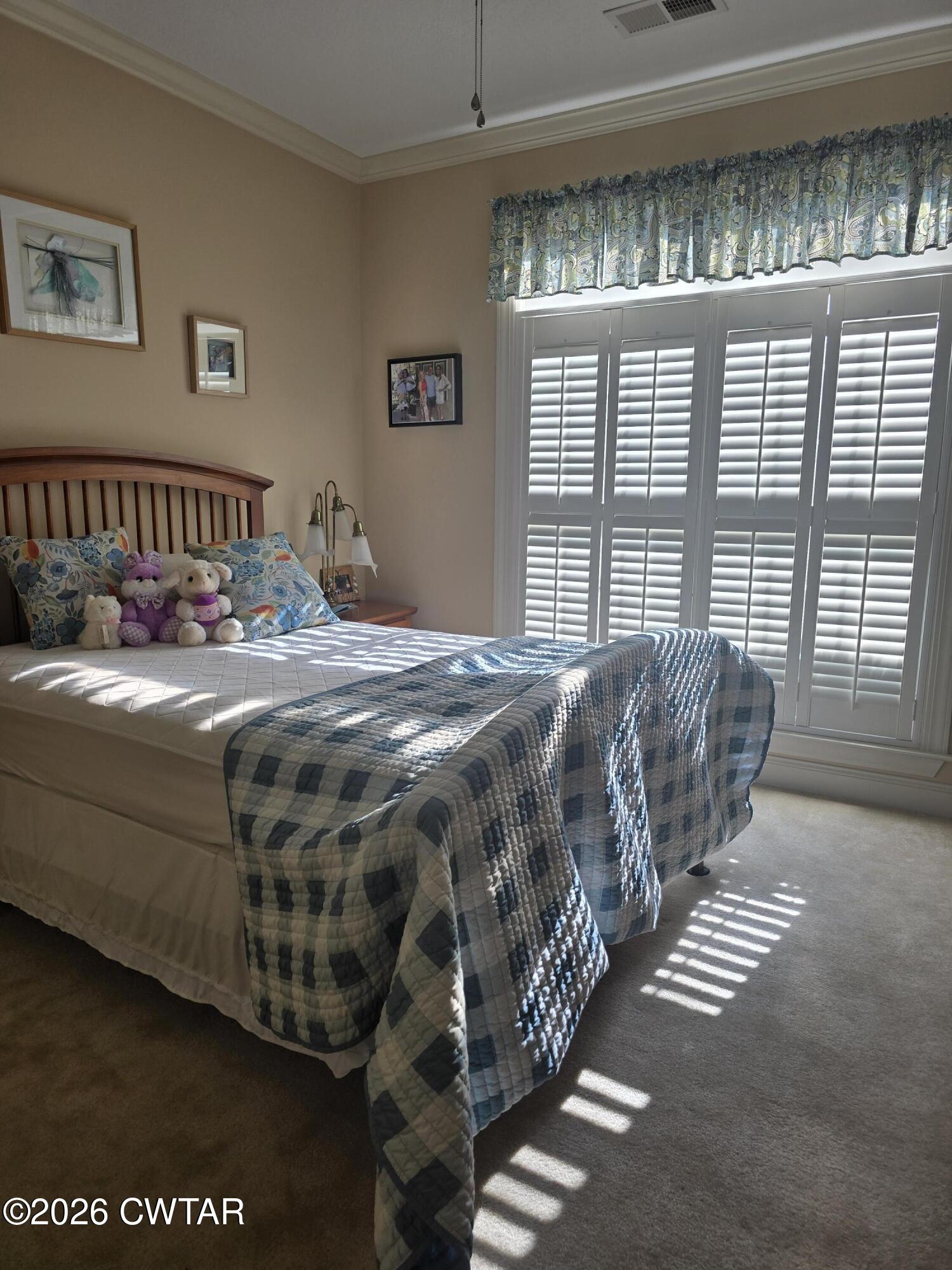 61 Emerald Ridge Cove Jackson, TN 38305 - Photo 11 of 24 a bed sitting in a bedroom next to a window