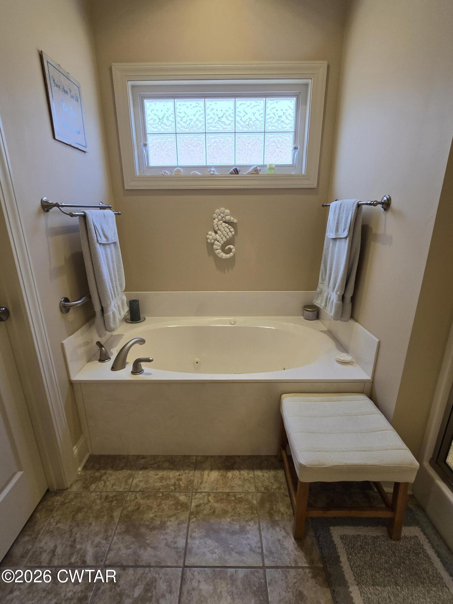 61 Emerald Ridge Cove Jackson, TN 38305 - Photo 15 of 24 a bathroom with a bathtub sink and vanity
