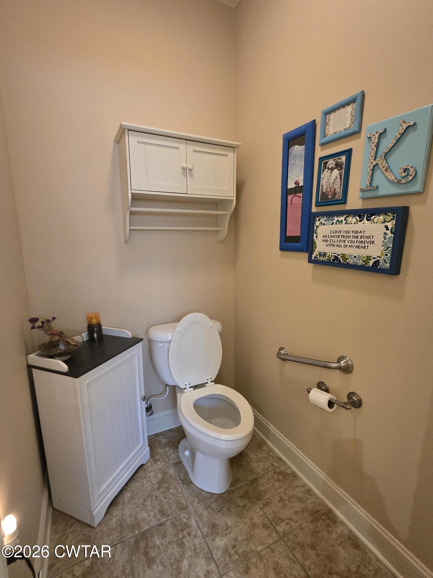 61 Emerald Ridge Cove Jackson, TN 38305 - Photo 18 of 24 a bathroom with a toilet and a mirror