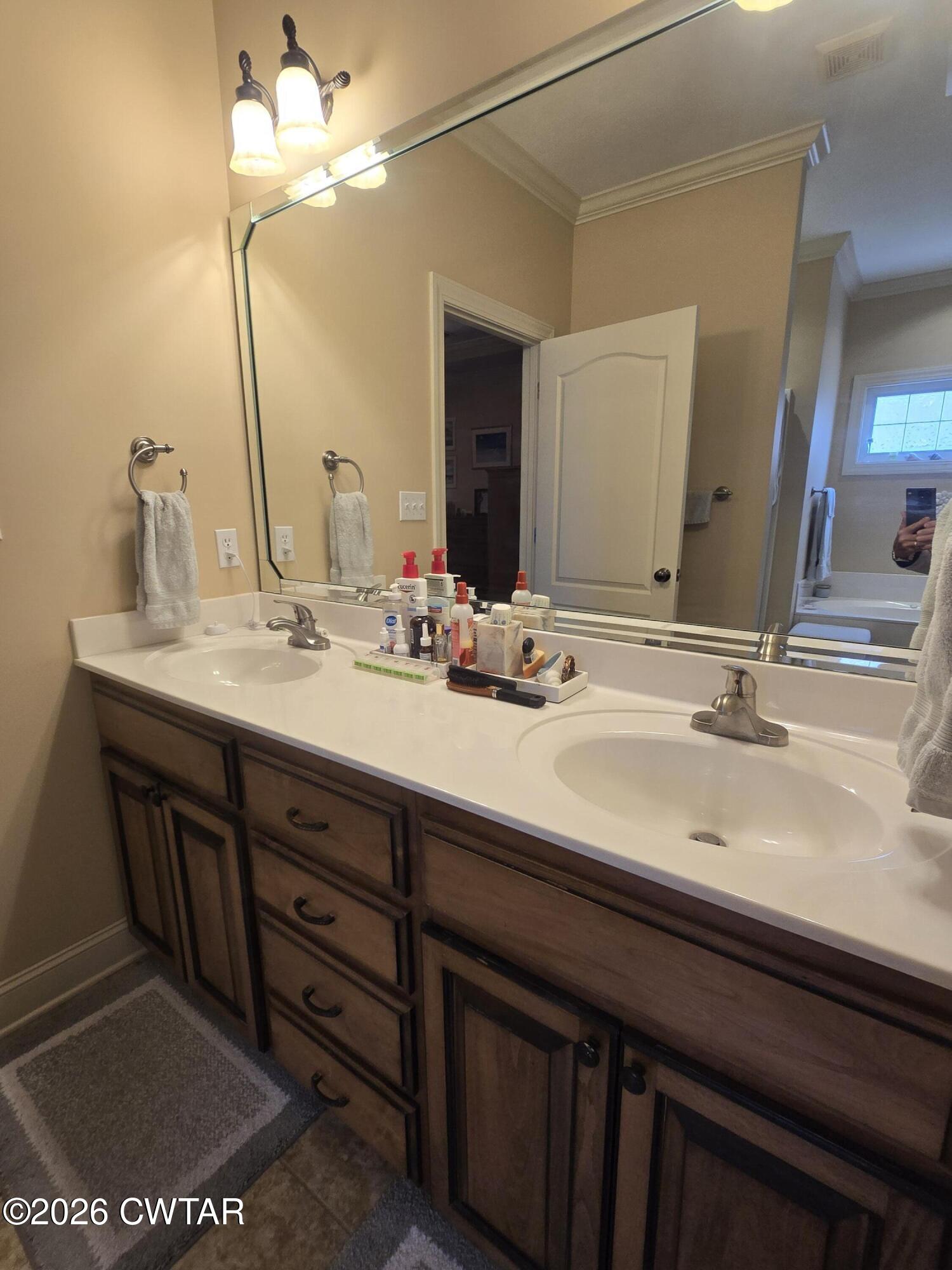 61 Emerald Ridge Cove Jackson, TN 38305 - Photo 19 of 24 a bathroom with a double vanity sink and a mirror