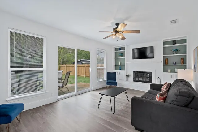 a living room with furniture a fireplace and a flat screen tv