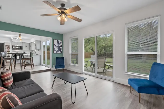 a living room with furniture and a large window with outer view