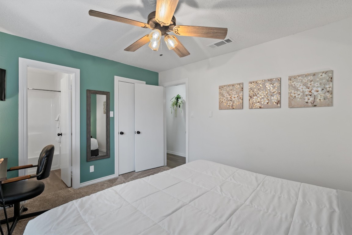 405 East Logan Street Round Rock, TX 78664 - Photo 17 of 23 a bedroom with a bed and a chandelier