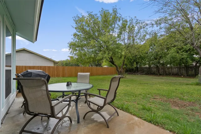 a view of a chairs and table in the garden
