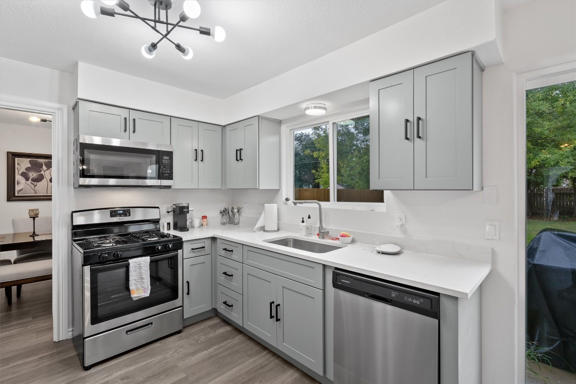 405 East Logan Street Round Rock, TX 78664 - Photo 7 of 23 a kitchen with a sink stove oven and microwave