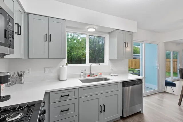 a bathroom with double sink and a window