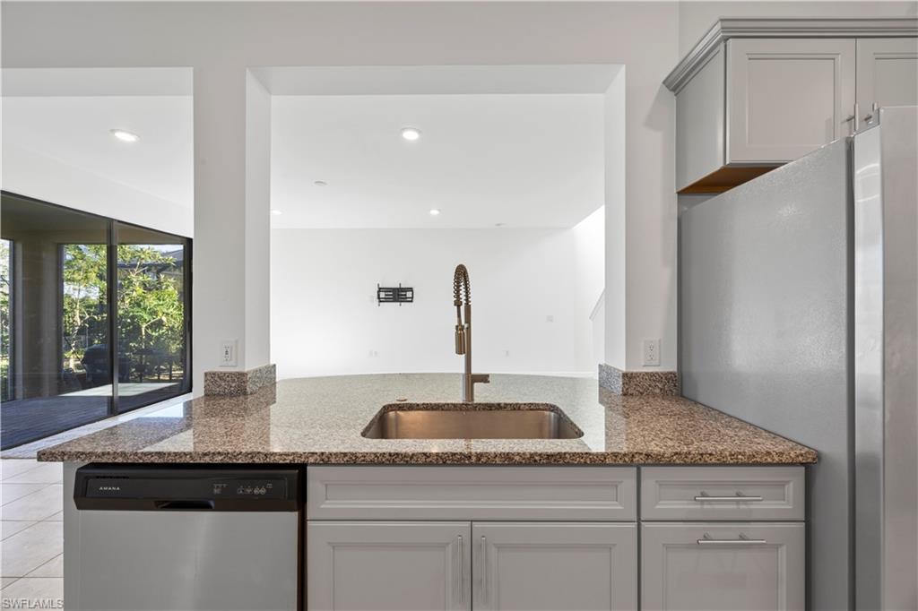 4583 Lamaida Lane Immokalee, FL 34142 - Photo 12 of 29 a kitchen with a sink and cabinets