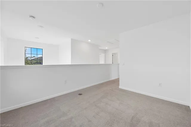 an empty room with a kitchen