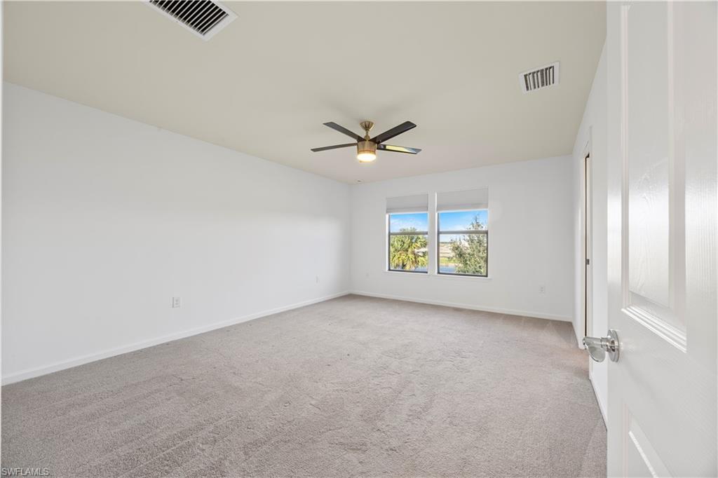 4583 Lamaida Lane Immokalee, FL 34142 - Photo 17 of 29 an empty room with window and ceiling fan