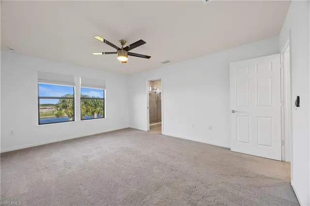 a view of a livingroom with a ceiling fan and window