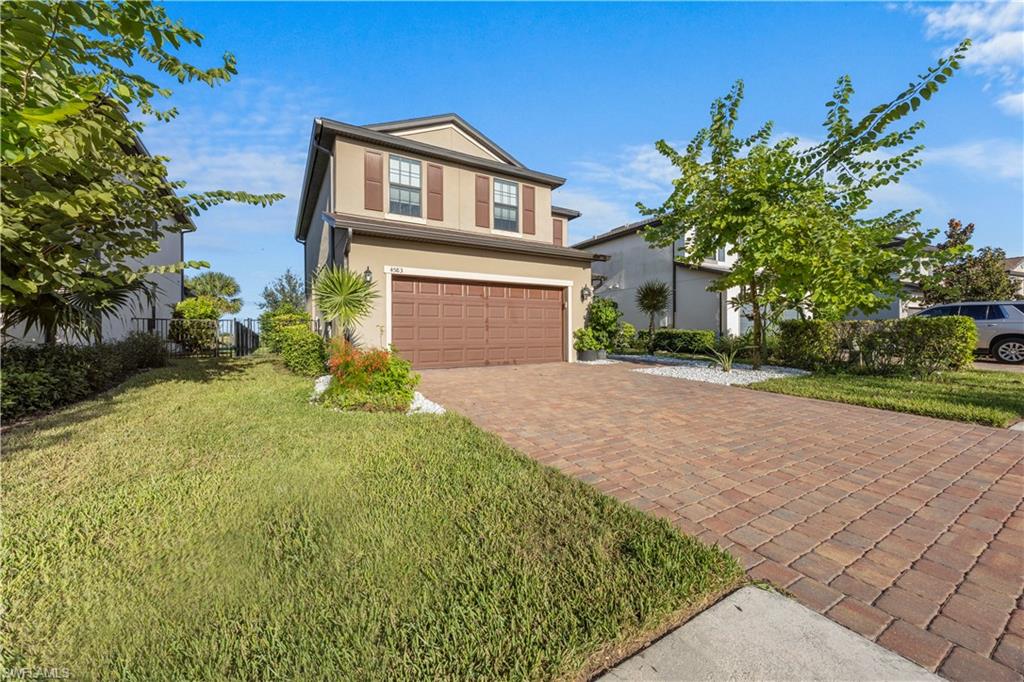 4583 Lamaida Lane Immokalee, FL 34142 - Photo 3 of 29 a front view of a house with a yard and garage