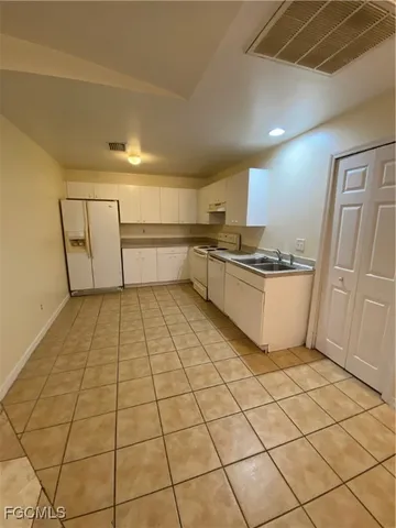 a kitchen with stainless steel appliances a sink and cabinets