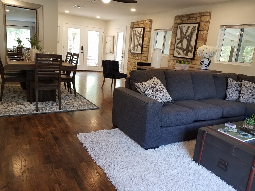 5405 Hudson Street Austin, TX 78721 - Photo 14 of 37 Rich hardwood floors unite the open-concept living and dining areas, creating a harmonious flow.