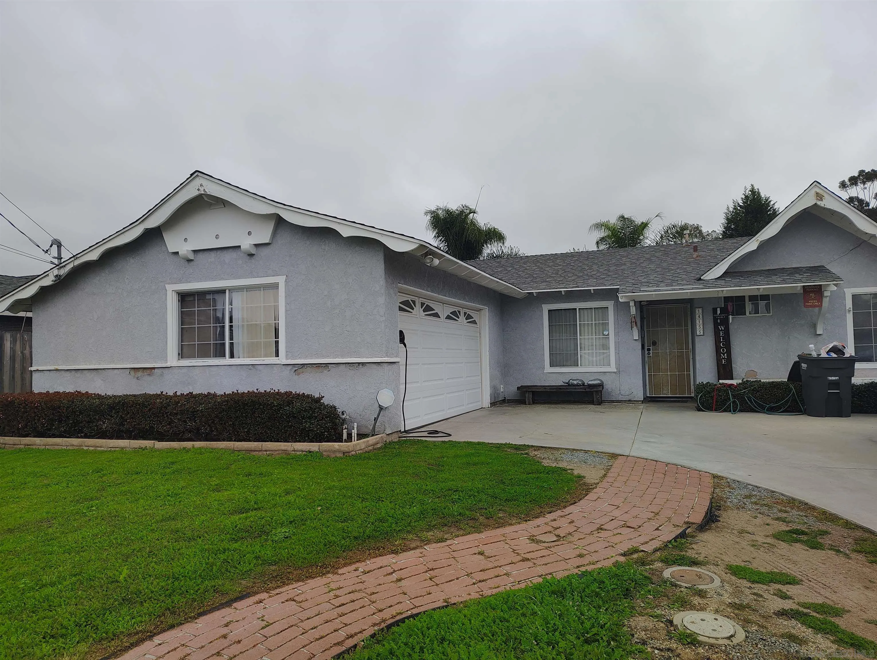 a front view of a house with a garden and yard